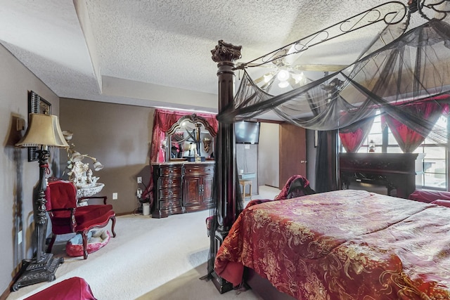 carpeted bedroom featuring a textured ceiling and ceiling fan