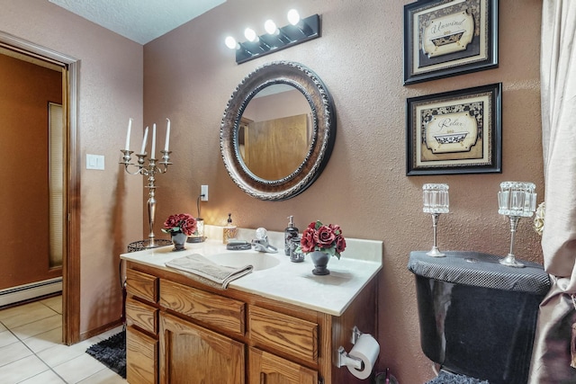 bathroom with tile patterned flooring, vanity, and a baseboard radiator