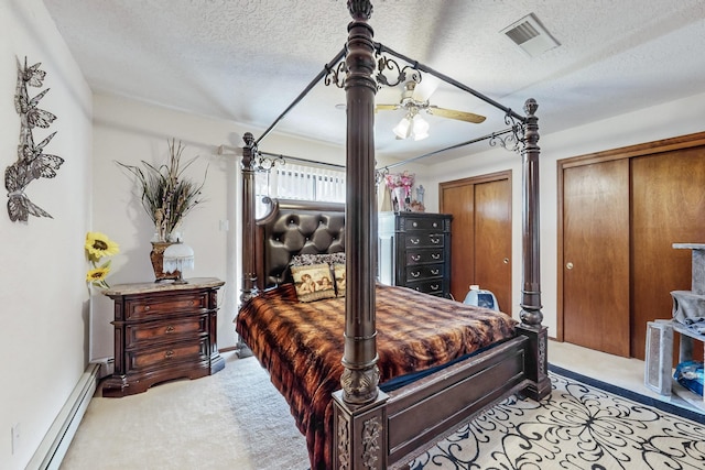 bedroom featuring a textured ceiling, light colored carpet, baseboard heating, and ceiling fan