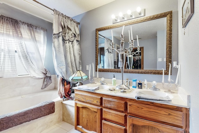 bathroom featuring tile patterned floors, a tub to relax in, and vanity