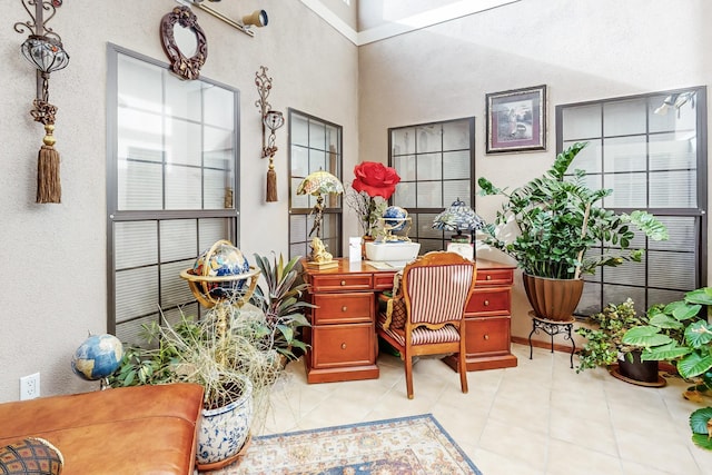 office area featuring light tile patterned floors and a high ceiling