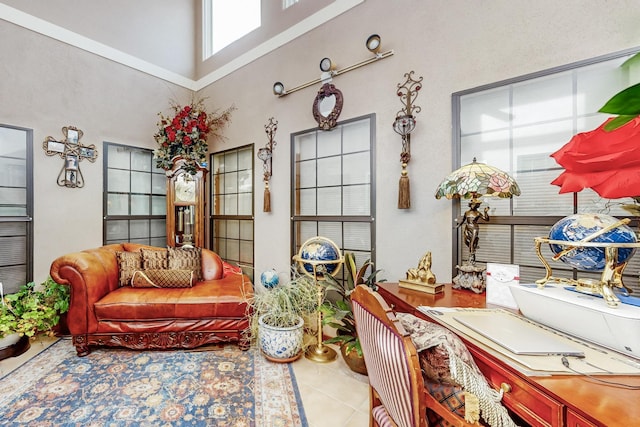 interior space with tile patterned floors and a high ceiling