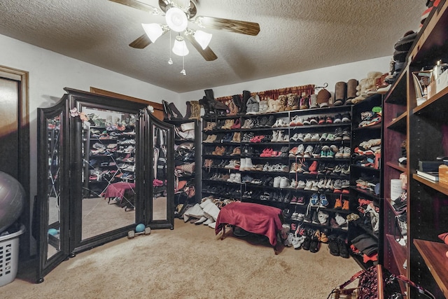 walk in closet with carpet and ceiling fan