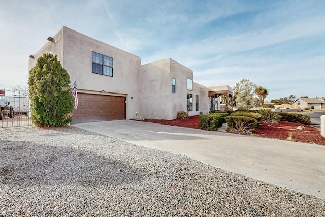 pueblo revival-style home featuring a garage