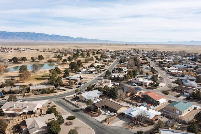 drone / aerial view with a water and mountain view