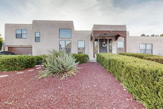 adobe home featuring a garage