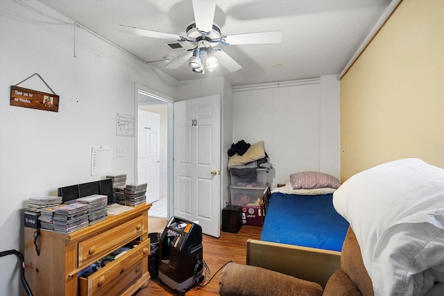 bedroom with ceiling fan and hardwood / wood-style floors
