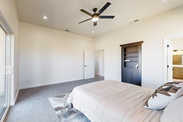 bedroom featuring dark colored carpet, ceiling fan, and connected bathroom