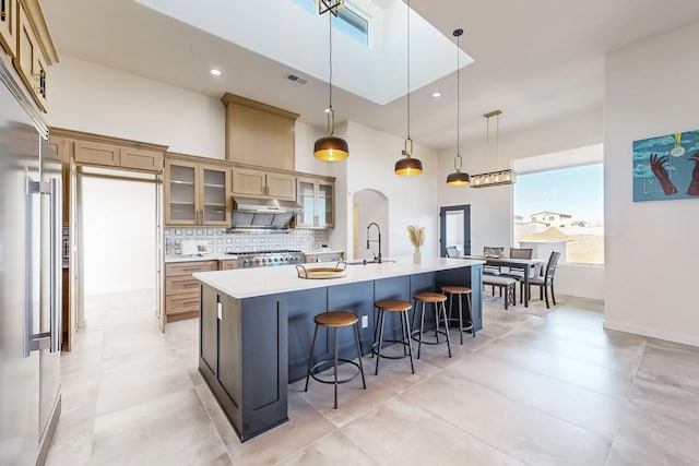 kitchen with a large island, hanging light fixtures, and a high ceiling