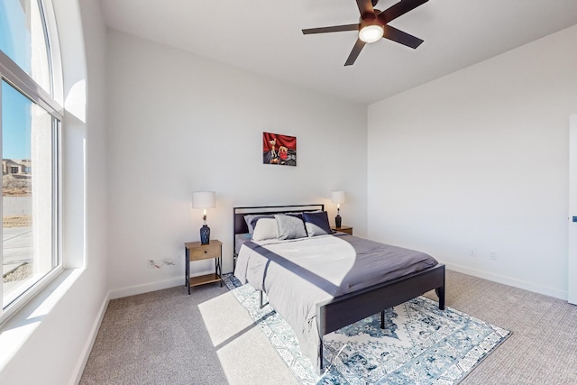 bedroom featuring ceiling fan and carpet