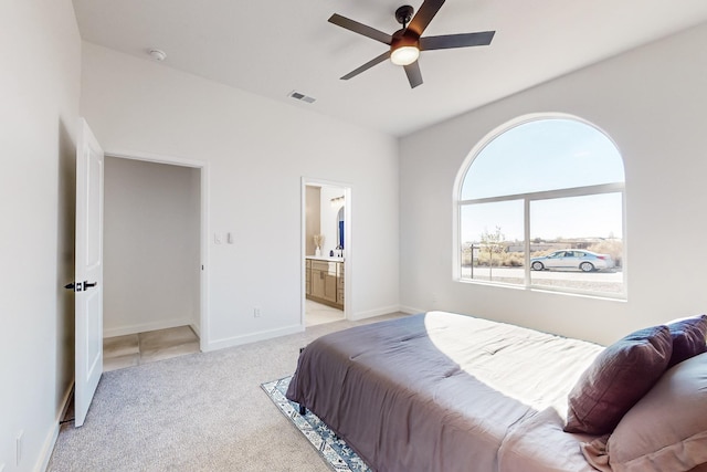 carpeted bedroom with ceiling fan and ensuite bathroom