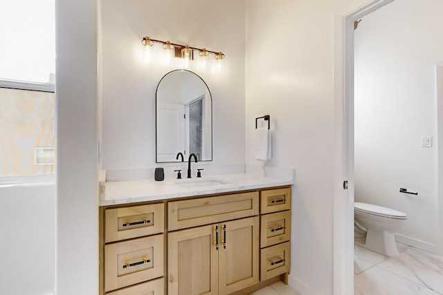 bathroom with vanity and toilet