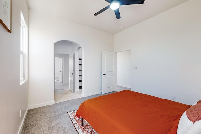 carpeted bedroom featuring ceiling fan and multiple windows