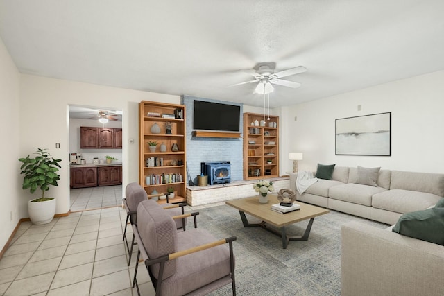 tiled living room with a wood stove and ceiling fan