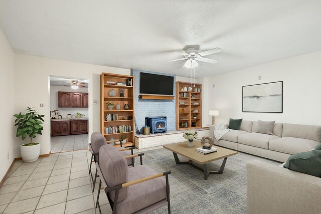 tiled living room featuring ceiling fan and a wood stove