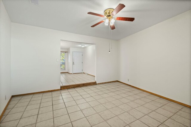 unfurnished room with ceiling fan and light tile patterned flooring