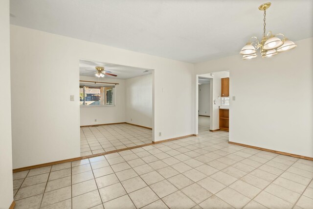 unfurnished room with light tile patterned floors and an inviting chandelier