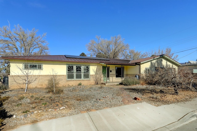 single story home with solar panels