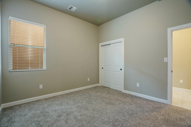 empty room featuring light colored carpet