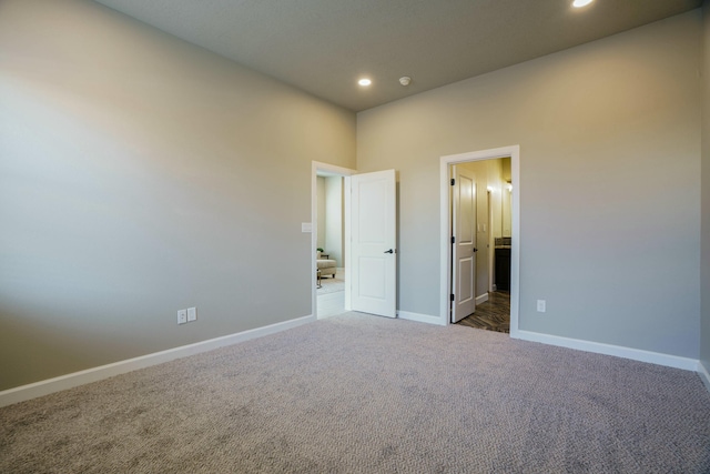 unfurnished bedroom with dark carpet