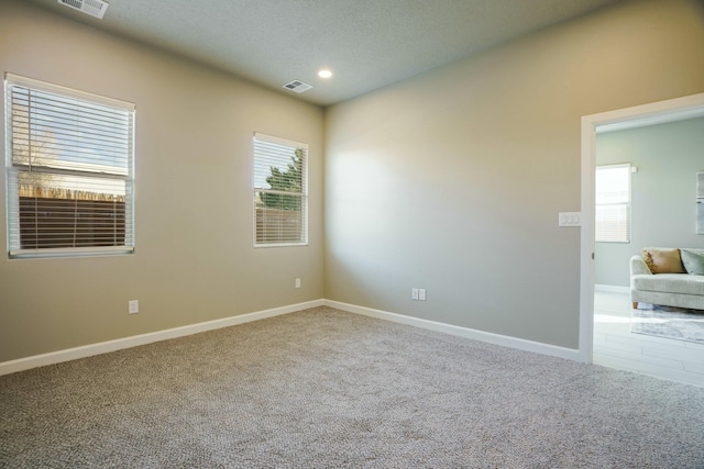 unfurnished room featuring carpet