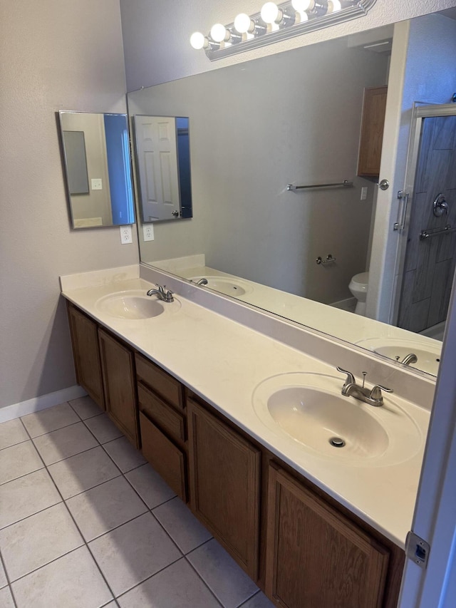 bathroom featuring toilet, vanity, tile patterned floors, and walk in shower