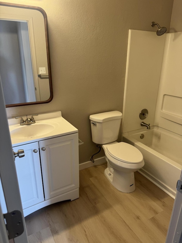 full bathroom with hardwood / wood-style flooring, vanity, toilet, and tub / shower combination