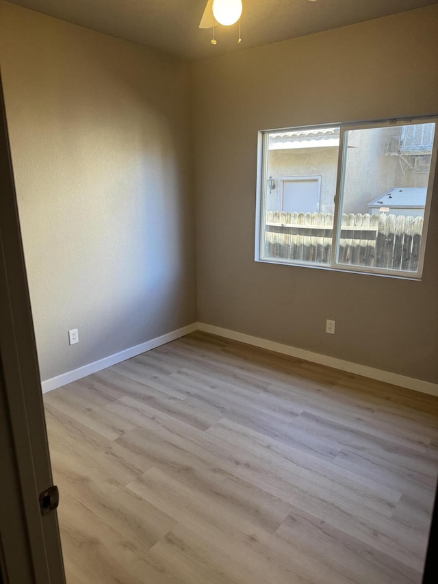 unfurnished room featuring ceiling fan and light hardwood / wood-style flooring