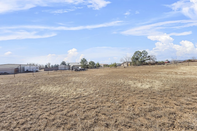 view of yard with a rural view