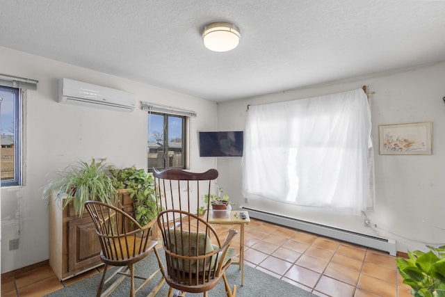 sitting room featuring a wall mounted AC, light tile patterned floors, a textured ceiling, and a baseboard heating unit