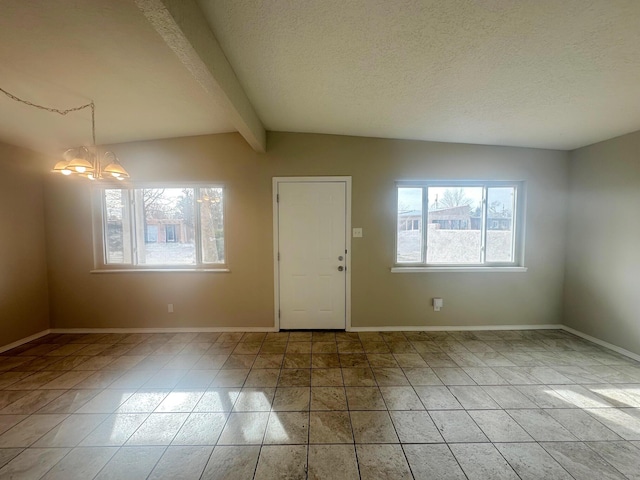 tiled entrance foyer featuring vaulted ceiling with beams, a textured ceiling, and an inviting chandelier