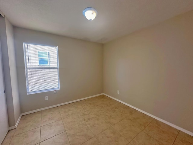 empty room with light tile patterned floors