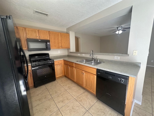 kitchen with a textured ceiling, ceiling fan, sink, black appliances, and light tile patterned floors