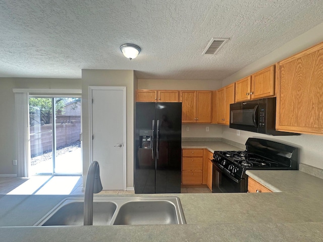 kitchen with sink and black appliances