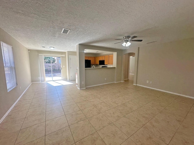 unfurnished living room with ceiling fan and light tile patterned flooring