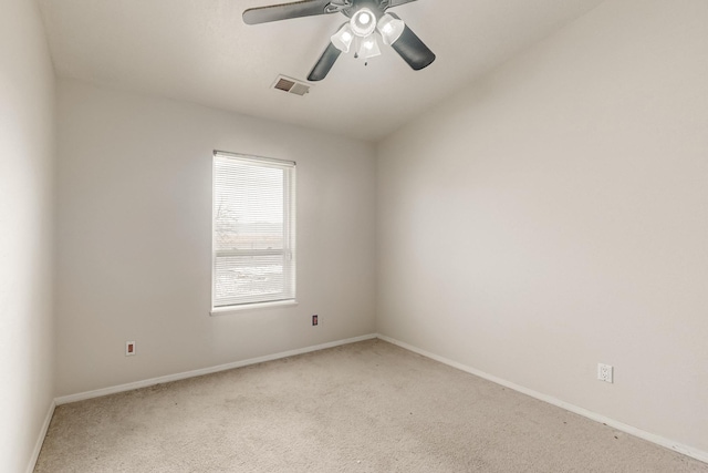 carpeted spare room featuring ceiling fan