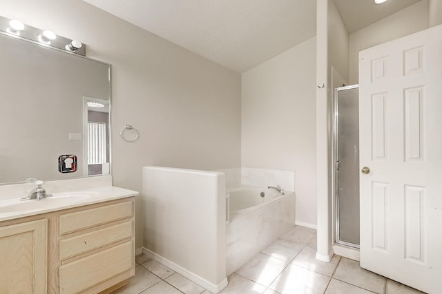 bathroom with tile patterned floors, vanity, and shower with separate bathtub