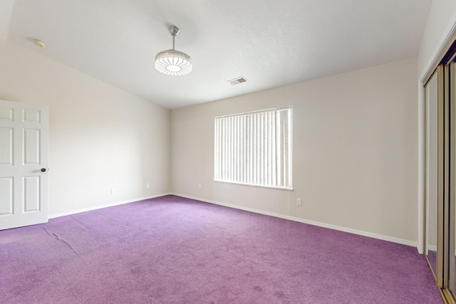 unfurnished bedroom with carpet flooring and a closet