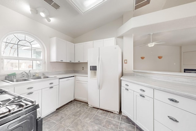 kitchen with white appliances, ceiling fan, sink, white cabinetry, and lofted ceiling