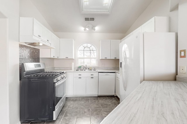 kitchen featuring sink, white cabinets, and white appliances