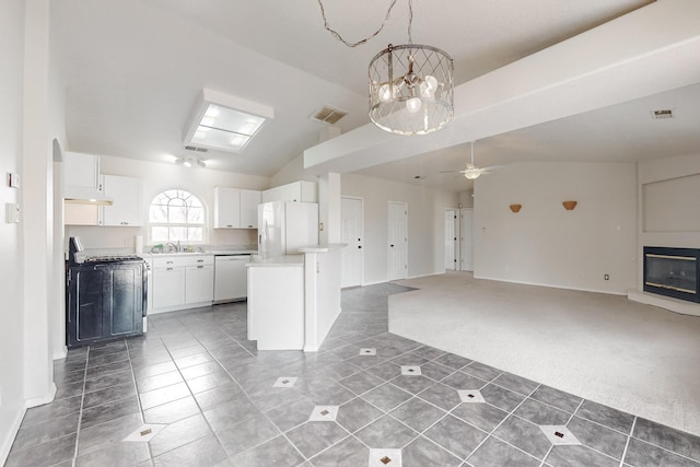 kitchen featuring white appliances, ceiling fan with notable chandelier, dark colored carpet, pendant lighting, and white cabinets