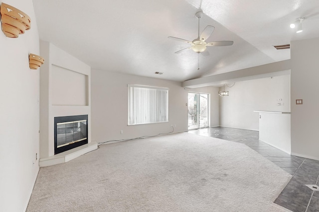 unfurnished living room with carpet flooring, ceiling fan, and lofted ceiling