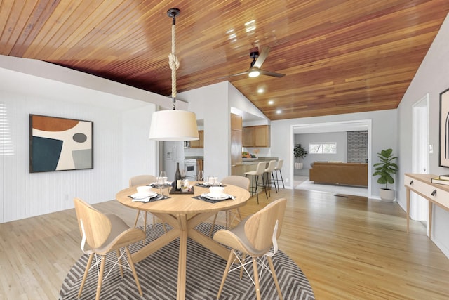 dining space featuring wood ceiling, vaulted ceiling, light wood-style flooring, and a ceiling fan