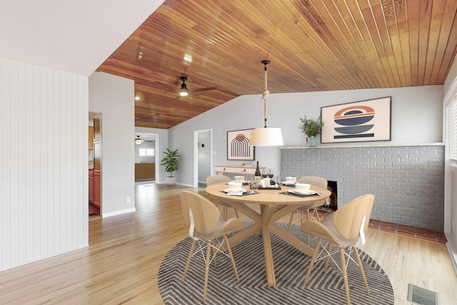 dining room with vaulted ceiling, ceiling fan, wood ceiling, and light hardwood / wood-style flooring