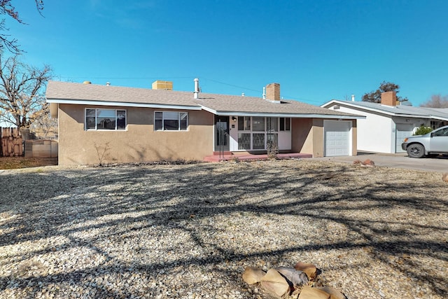 single story home with a garage and a sunroom