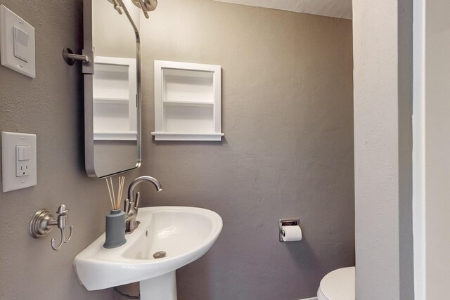 bathroom featuring sink and toilet