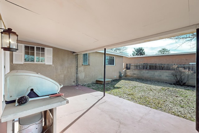 view of patio / terrace featuring a grill and fence