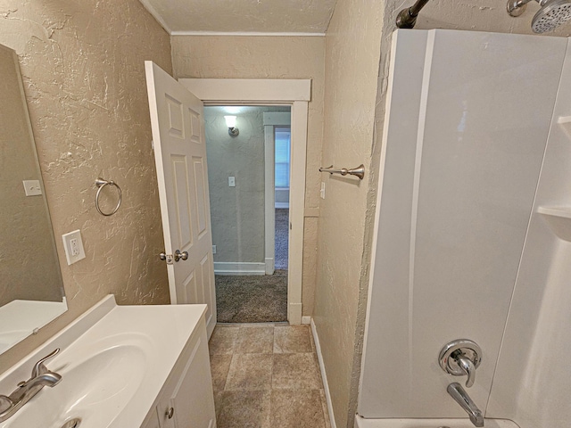 bathroom featuring vanity, ornamental molding, and shower / washtub combination