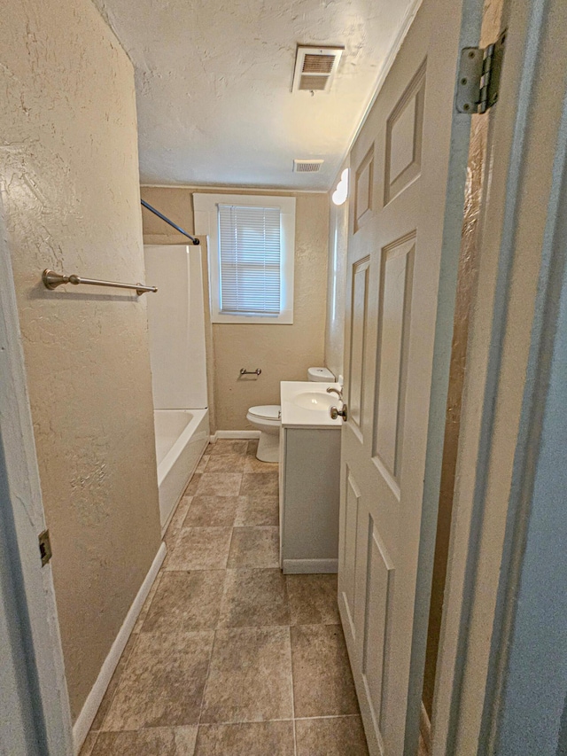 full bathroom featuring vanity, shower / bathtub combination, toilet, and a textured ceiling