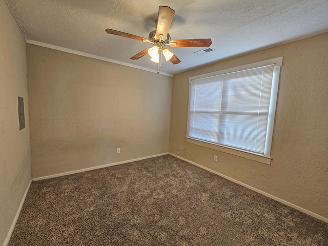 spare room with dark colored carpet, ceiling fan, and a textured ceiling